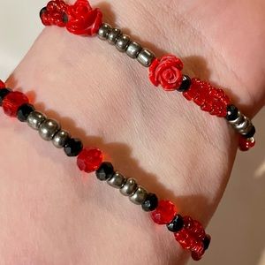 2 Stack of red, black & silver themed bracelets featuring vintage dangling charm